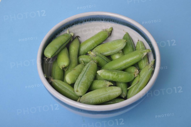 Peas in a bowl on a blue background