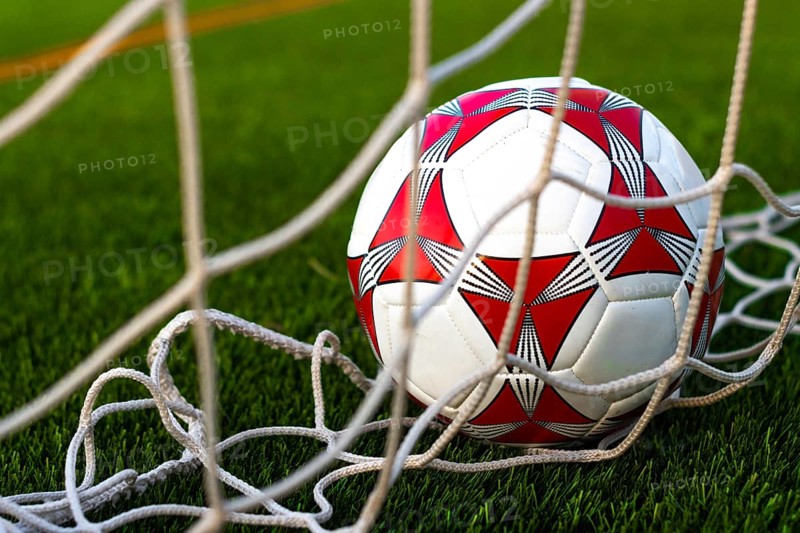 Close up of soccer ball inside the net field. Soccer ball inside the goal field. Football fever concept