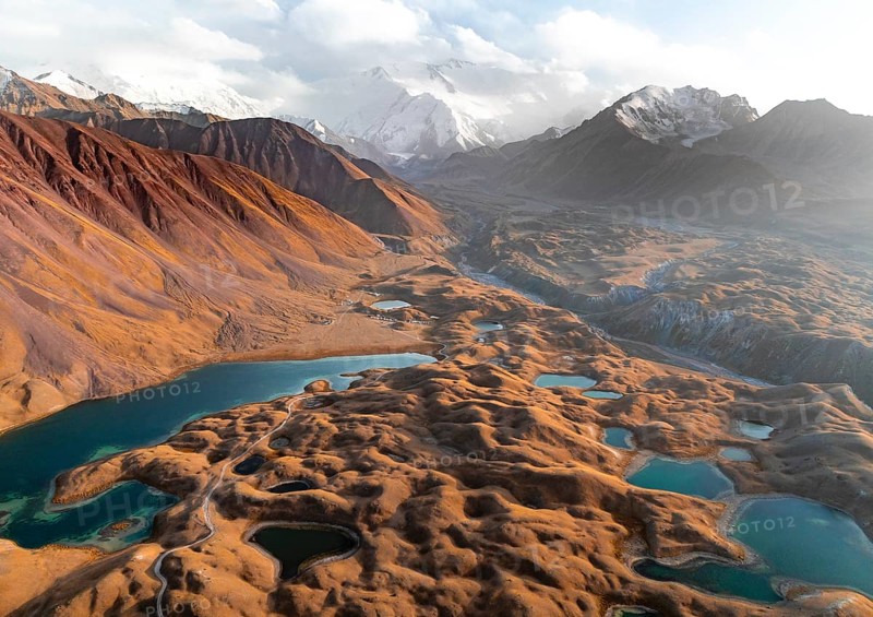 Atmospheric aerial view, high mountain landscape with glacier moraines and mountain lakes, behind Pik Lenin, Trans Alay Mountains, Pamir Mountains, Osher Province, Kyrgyzstan, Asia