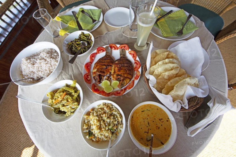 Traditional Kerala dishes, striped cichlid in the centre, Kerala, India, Asia