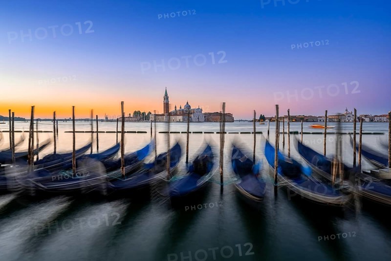 Venetian gondolas, boat dock at St Mark's Square, church of San Giorgio Maggiore in the background, long exposure at sunrise, Venice, Veneto, Italy, Europe