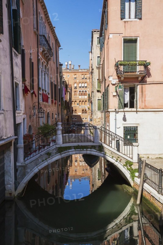 San Angelo Canal with footbridge and old pinkish and white architectural style residential buildings, San Marco dsitrict, Venice, Veneto, Italy, Europe