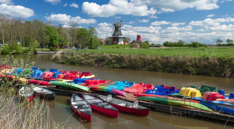 The Greetsiel twin mills, in front boats in the new Greetsieler Sieltief, Greetsiel, Krummhoern, East Frisia, Lower Saxony, Germany, Europe