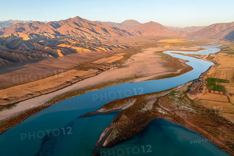 Naryn River between mountains and fields, at Toktogul Reservoir at sunset, aerial view, Kyrgyzstan, Asia