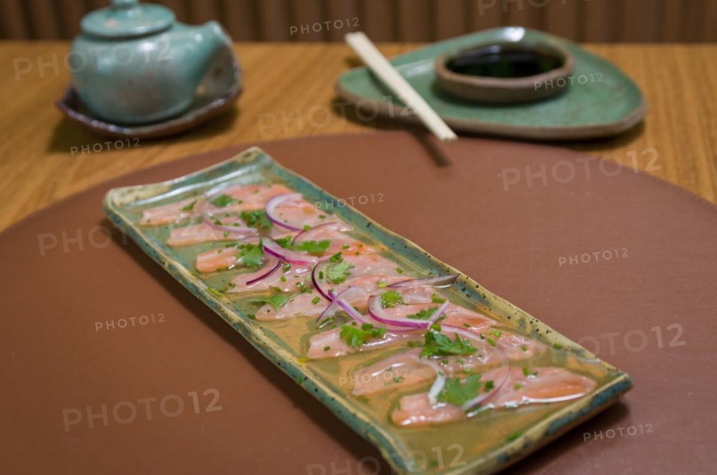 Delicious premium salmon sashimi arranged on an elegant handmade platter