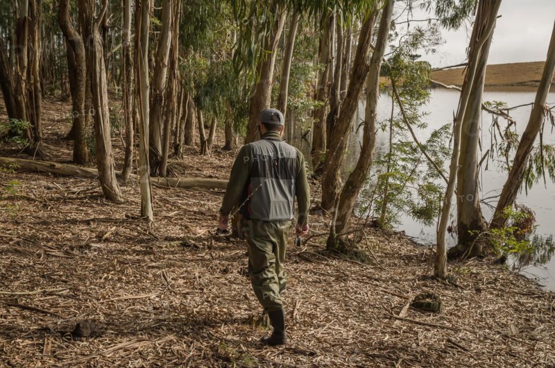 Sport fisherman fishing in lake on cloudy day, Cambara do sul, Rio Grande do sul, Brazil, South America