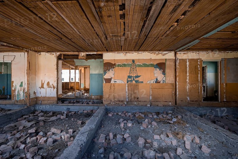 Destroyed abandoned classroom of the old school, wall painting with Soviet miners, ghost town, Engilchek, Tian Shan, Kyrgyzstan, Asia