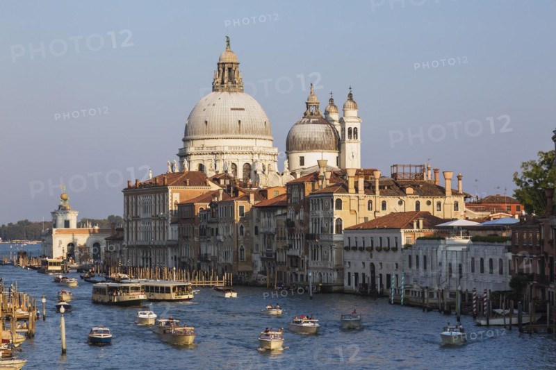 Water taxis and vaporettos on Grand Canal with Renaissance architectural style palace buildings and Santa Maria della Salute basilica in Dorsoduro, Venice, Veneto, Italy, Europe