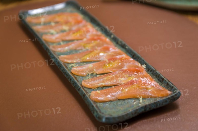 Delicious premium salmon sashimi arranged on an elegant handmade platter