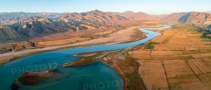 Naryn River between mountains and fields, at Toktogul Reservoir at sunset, aerial view, Kyrgyzstan, Asia