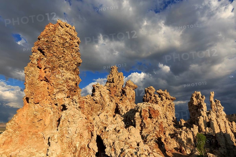 Sunlit tufa rocks against dark clouds, near the golden hour, Mono Lake, North America, USA, South-West, California, California, North America