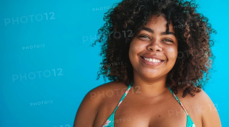 A plus size black afro-american bikini model with curly hair is smiling and wearing a bikini top. Concept of confidence and happiness, AI generated