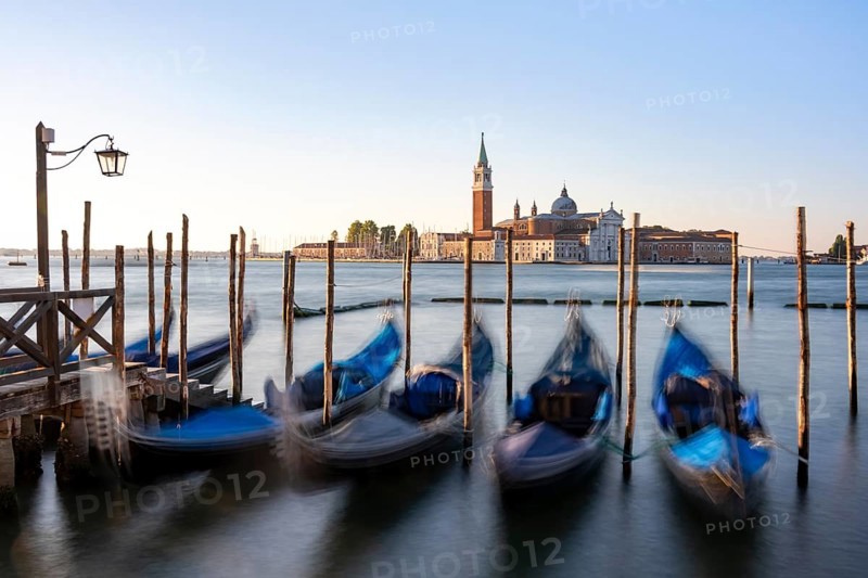 Venetian gondolas, boat dock at St Mark's Square, church of San Giorgio Maggiore in the background, long exposure in the morning light, Venice, Veneto, Italy, Europe