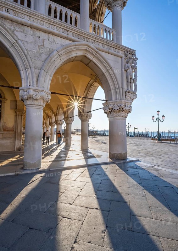 Colonnade of the Doge's Palace with Sun Star in the Piazetta San Marco, St Mark's Square, Venice, Veneto, Italy, Europe