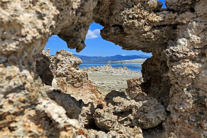 View through a natural rock opening to a quiet landscape with blue sky in the background, Mono Lake, North America, USA, South-West, California, California, North America