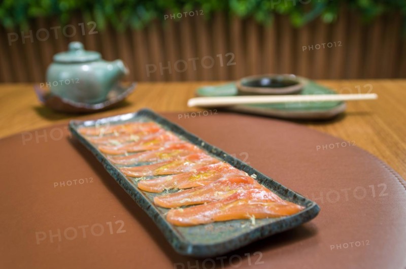 Delicious premium salmon sashimi arranged on an elegant handmade platter