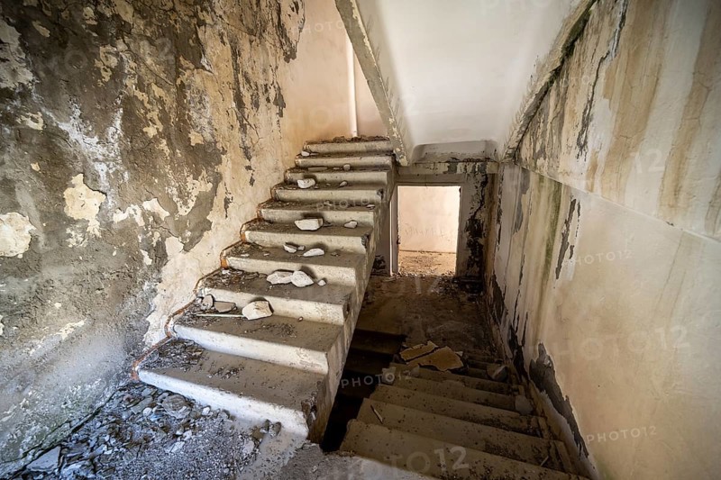 A crumbling staircase in an abandoned building with peeling paint and visible decay, ghost town, Engilchek, Tian Shan, Kyrgyzstan, Asia