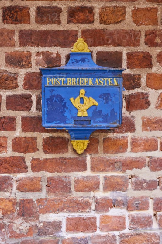 Old blue post box on a brick facade in Boettcherstrasse in Bremen, Hanseatic city, state of Bremen, Germany, Europe