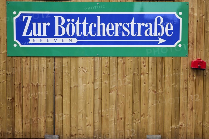 Signpost to Boettcherstrasse on a wooden fence in Bremen, Hanseatic City, State of Bremen, Germany, Europe