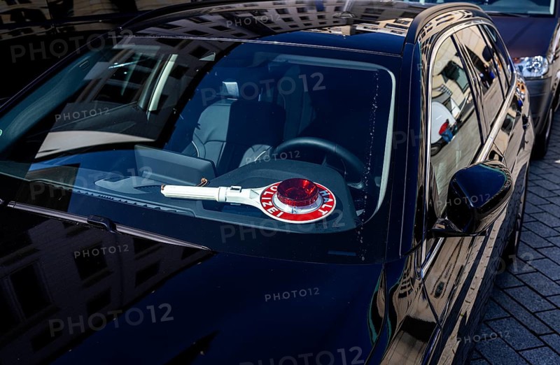 Parked police vehicle with red stop stick behind the windscreen, Berlin, Germany, Europe