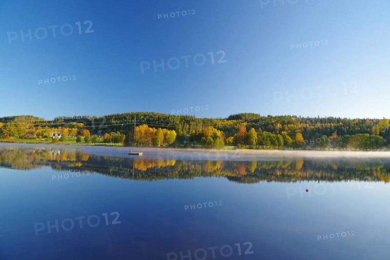 Autumn morning mist over a calm lake, foliage colouring, Bullaren, Bohuslaen. Sweden