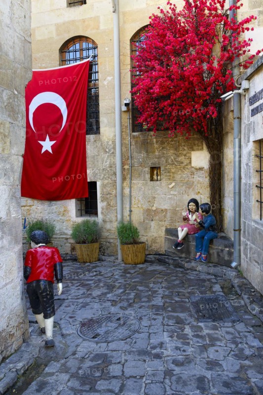 Doll mannequins and Turkish flag in a narrow street, Gaziantep, Turkey, Asia