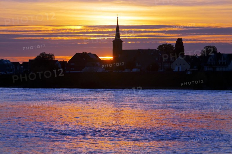 Rhine at sunset with the church of St Dionysius in Volmerswerth, Duesseldorf, Lower Rhine, North Rhine-Westphalia, Germany, Europe