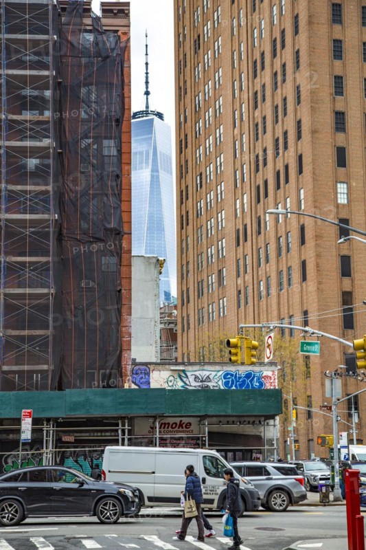 The One World Trade Centre can be seen at the end of a street canyon, Lower Manhattan, New York City