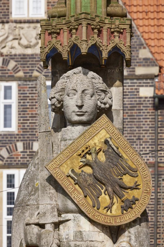 Head, sword and coat of arms of the Roland of Bremen in front of a brick facade in Bremen, Hanseatic city, federal state of Bremen, Germany, Europe