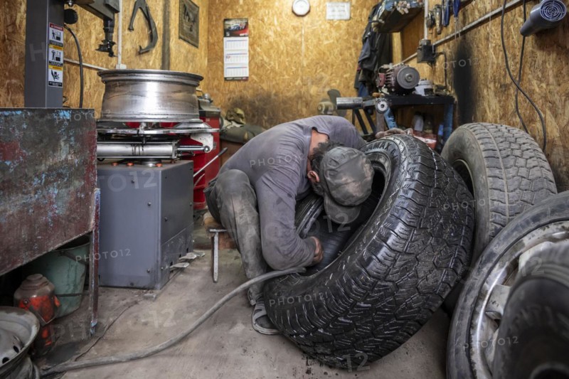 Workshop, man repairing a hole in a car tyre, Kyrgyzstan, Asia