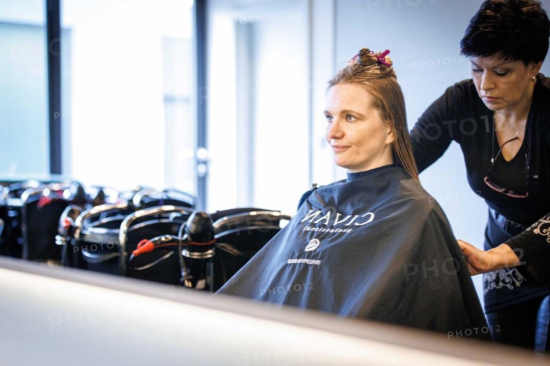Valentyna Vysotska, hairdresser from Ukraine, bleaks her customer's hair, taken at the hairdressing salon Coiffeur Sivan in Berlin, 22/04/2024