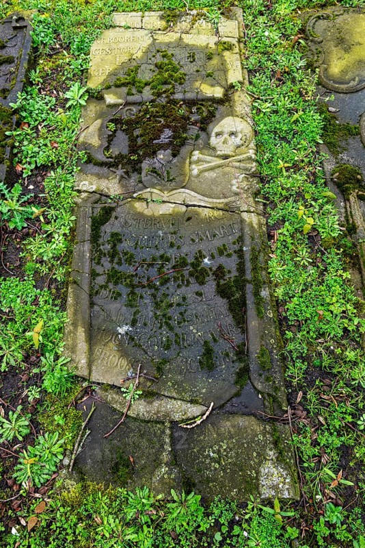Weathered historical gravestone in the churchyard, Protestant Reformed St George's Church in the small town of Weener, district of Leer, Rheiderland, East Frisia, Lower Saxony, Germany, Europe
