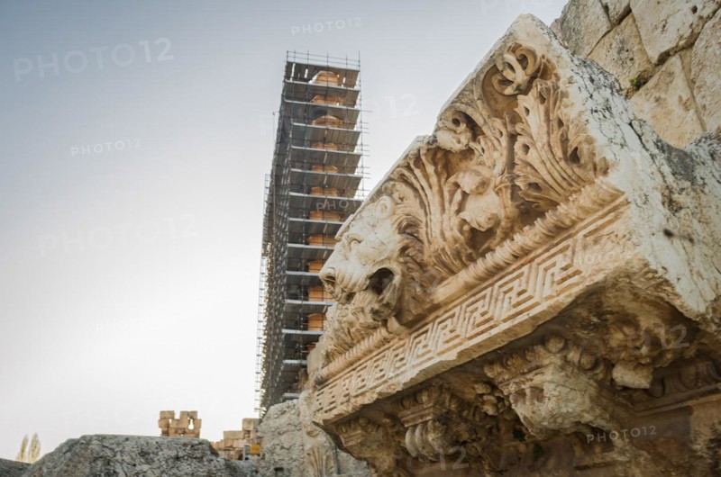 Ruins of Baalbek. Ancient city of Phenicia, located in the Beca valley, Lebanon. Acropolis with Roman remains. Roman tower being restored, moon in the sky