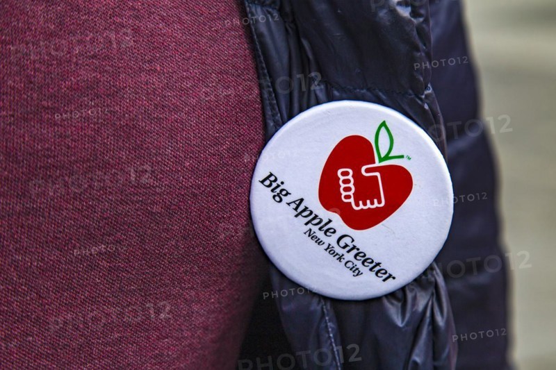Plaque of the Big Apple Greeter. The Big Apple Greeters are a voluntary organisation. They show visitors their own personal New York on small private tours