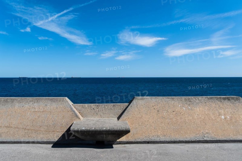 Concrete benches on the Moll de Llevant waterfront promenade, a 4.5 km long promenade for joggers, walkers, cyclists and skaters at the harbour of Tarragona, Spain, Europe