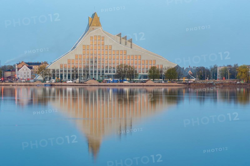 Latvian National Library reflected in the Daugova River, designed and built by Latvian-born US architect Gunars Birkerts, building is also called Gaismas pils (Castle of Light), Riga, Latvia, Europe
