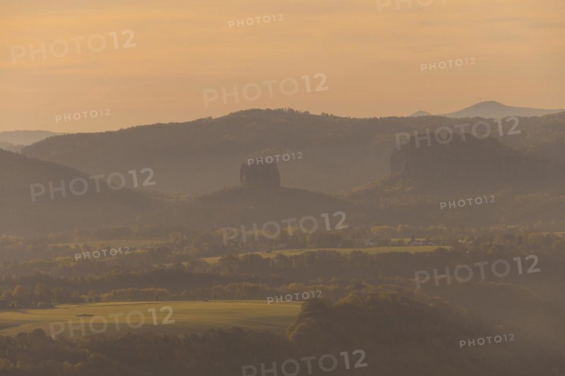 Sunrise on the Lilienstein. The Lilienstein is the most striking and best-known rock in the Elbe Sandstone Mountains. Distant view of the Falkenstein with the Schrammsteine, Ebenheit, Saxony, Germany, Europe