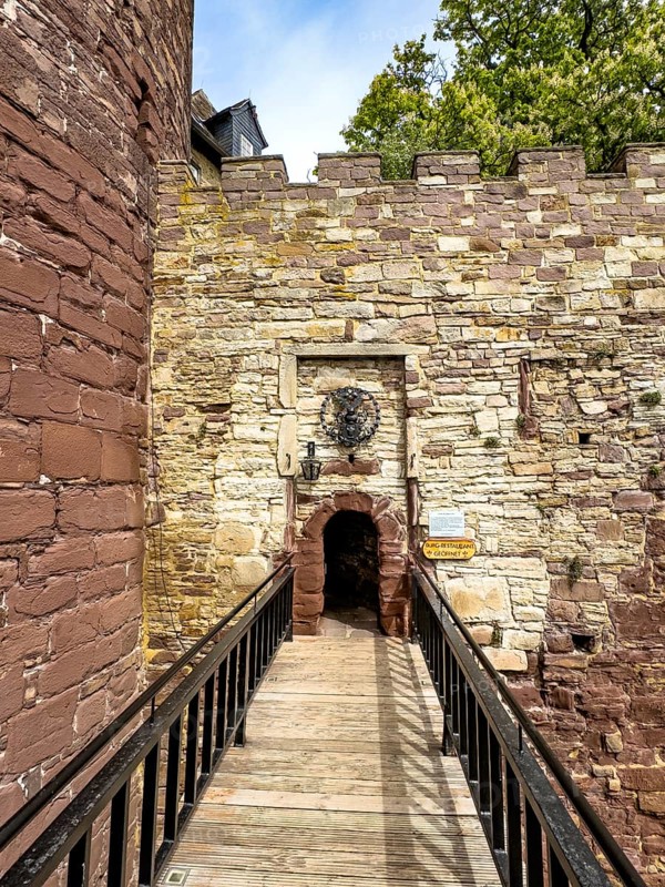 View over a fortified bridge to a small, narrow castle courtyard of the 13th century Trendelburg Castle, today Burghotel Trendelburg, Trendelburg, Weserbergland, Hesse, Germany, Europe