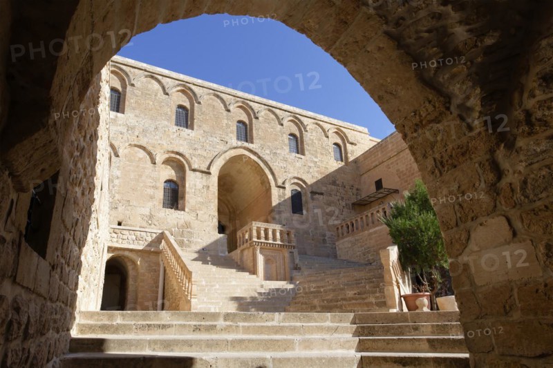 Entrance to Saint Ananias Monastery known as Deyrulzafaran or Saffron Monastery viewed through an arch, Mardin, Turkey, Asia