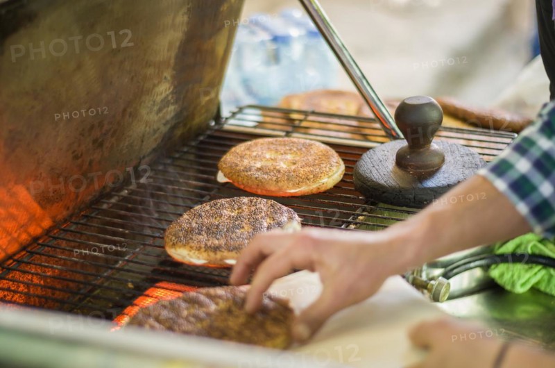 Lebanese man preparing typical sesame and cheese bread, center of Tripoli, northern Lebanon city. Lebanese street cooking