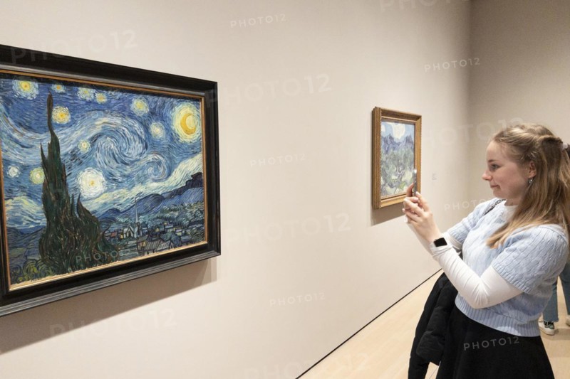 Visitor photographing Van Gogh's painting Starry Night, Museum of Modern Art MoMa, Midtown Manhattan, New York City