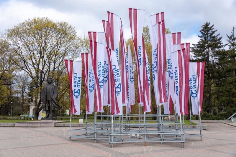 Latvian flags with the inscription Latvija Nato 20 fly at the monument to the teacher and poet Andrejs Upits at Kronvalda Park in Riga, Latvia, Europe