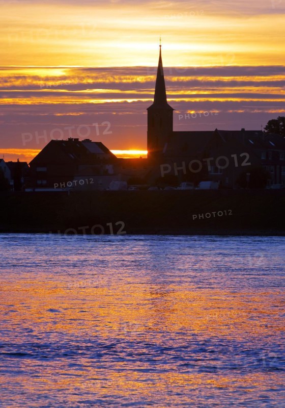 Rhine at sunset with the church of St Dionysius in Volmerswerth, Duesseldorf, Lower Rhine, North Rhine-Westphalia, Germany, Europe