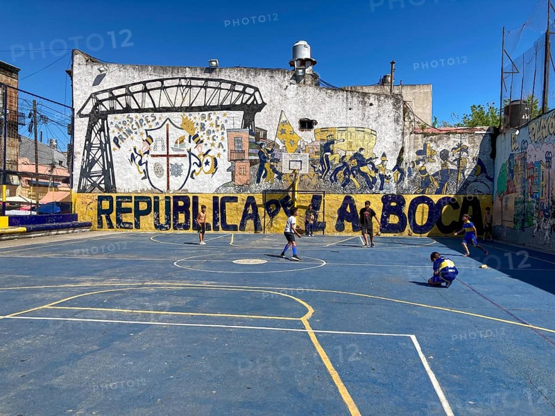 Children playing football on a sports field in the La Boca neighbourhood near the Boca Juniors football club, Buenos Aires, Argentina, South America