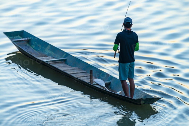 Fisherman with boat on the Mekong, Luang Prabang, Laos, Asia