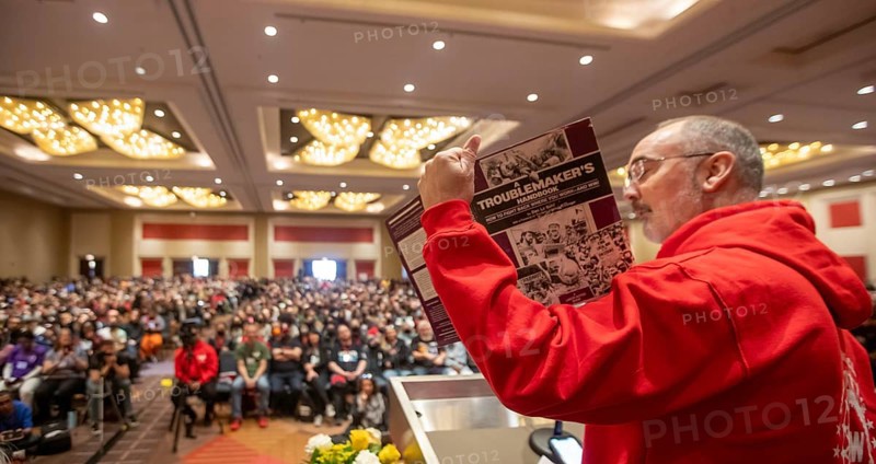 Chicago, Illinois, Shawn Fain, president of the United Auto Workers union, speaks at the conclusion of the 2024 Labor Notes conference. That event brought together 4, 700 union activists who are working to revitalize the labor movement. Fain is holding the Labor Notes publication, A Troublemaker's Handbook, which he called his bible as a union activist