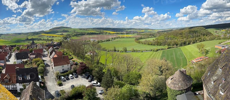 Panoramic view from large castle tower tower of 13th century castle today castle hotel Trendelburg on village Trendelburg and fields in spring, lower right small castle tower, Weserbergland, Hesse, Germany, Europe
