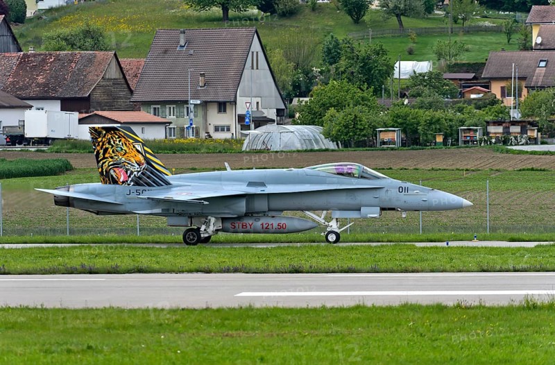 Swiss Air Force squadron aircraft J-5011 of the type McDonnell Douglas FA 18C Hornet with tiger livery on the vertical stabiliser, Payerne military airfield, Payerne, Vaud, Switzerland, Europe