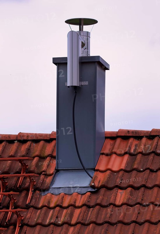 Retrofitted chimney on roof, with dust separator, electrostatic filtering of soot particles from the inside of the flue pipe, power connection, building services, Stuttgart, Baden-Wuerttemberg, Germany, Europe