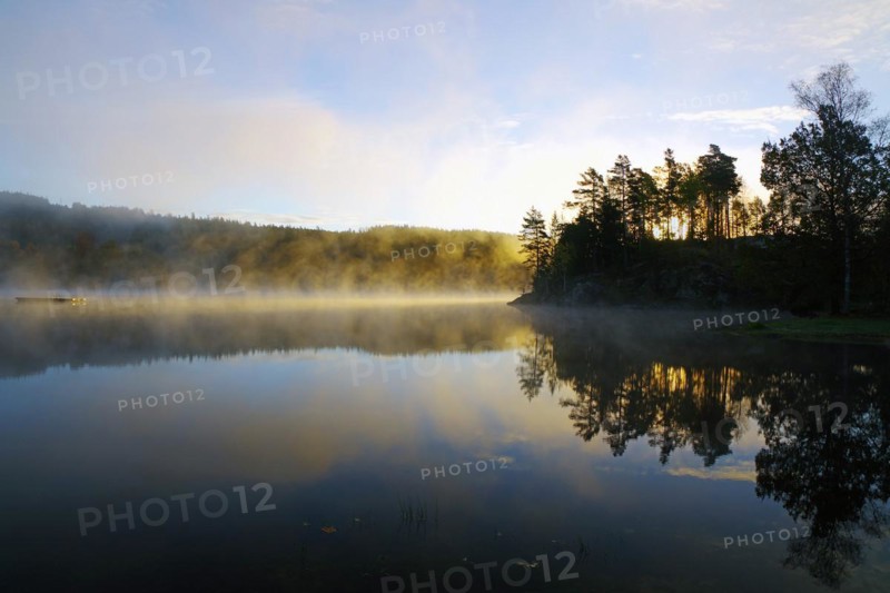 Autumn morning mist over a calm lake, foliage colouring, Bullaren, Bohuslaen. Sweden